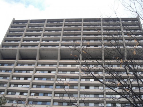 The upper six floors offer two-bedroom apartments, the lower 14 offer one-bedrooms (excluding the offices on the first floor), and a shared-space community floor separates the two modules.
